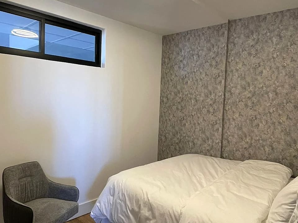 Second bedroom with comfortable bedding and natural light