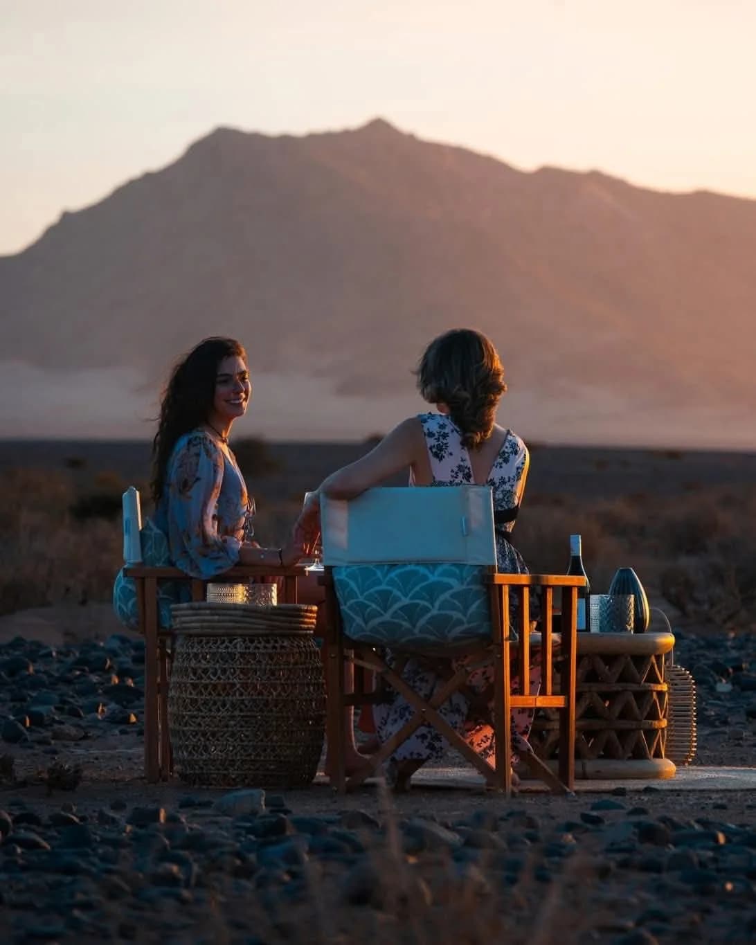 Women at desert dinner during sunset