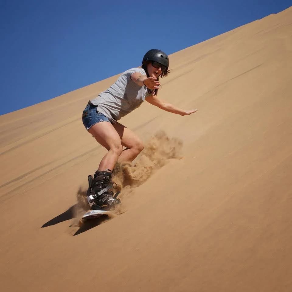 Woman standing with sandboard
