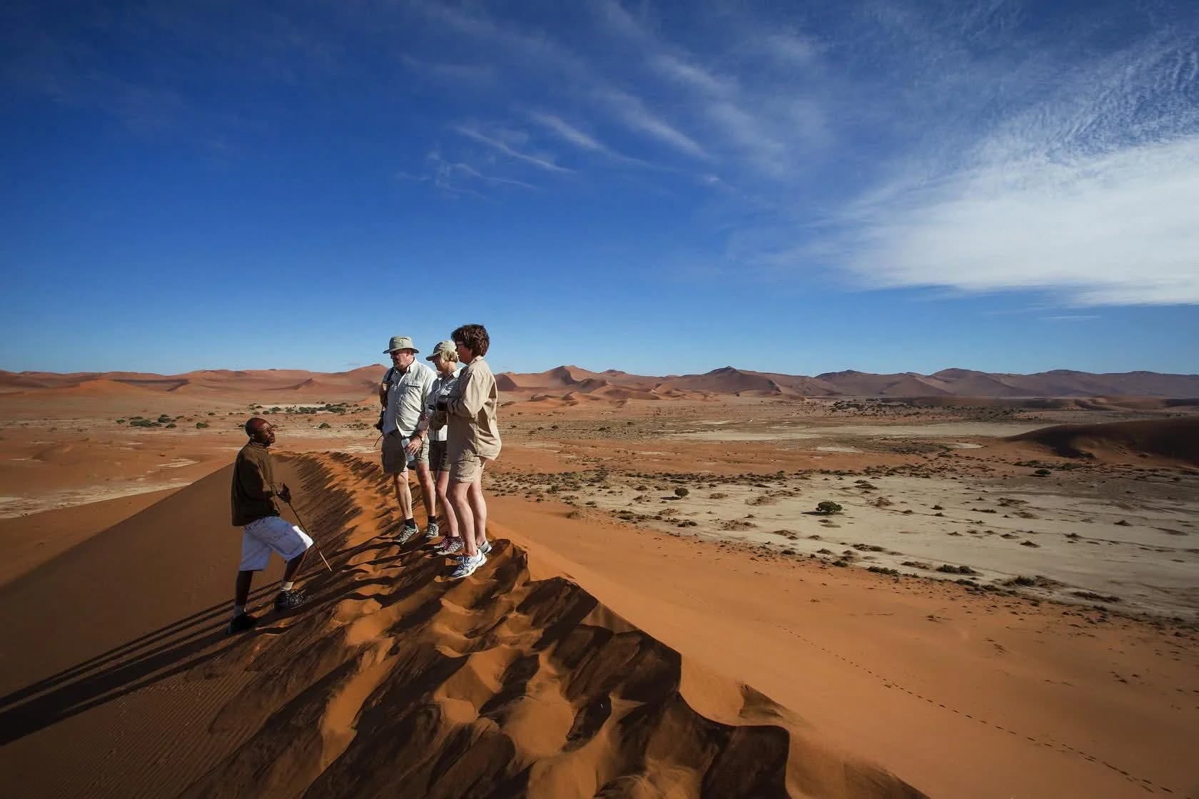 Guide with tourists on Sossusvlei dune