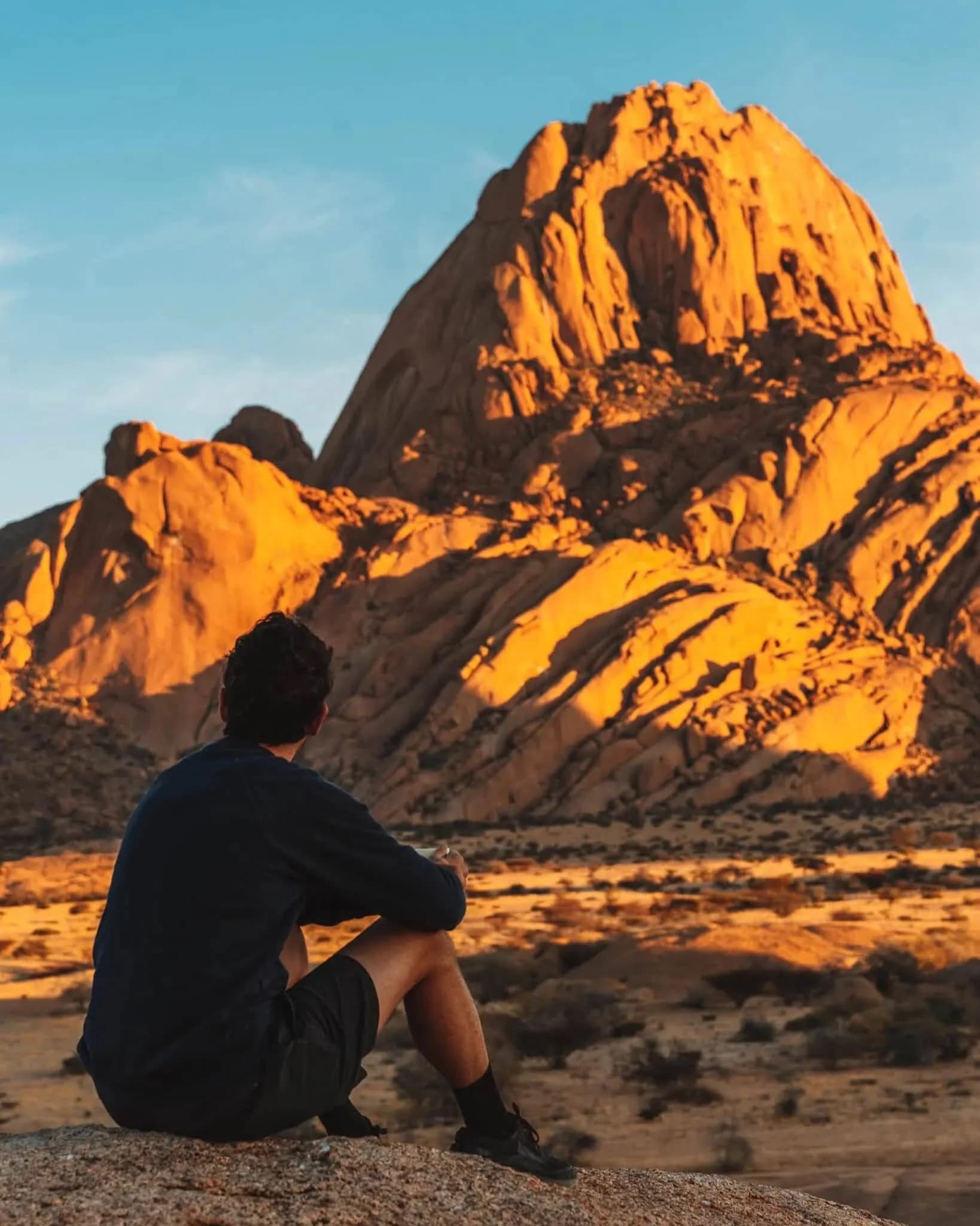 Man sitting at Spitzkoppe sunset