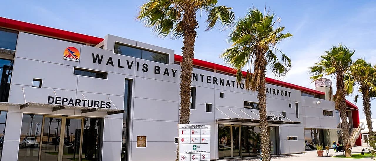 Walvis Bay International Airport exterior with DEPARTURES and ARRIVALS signage