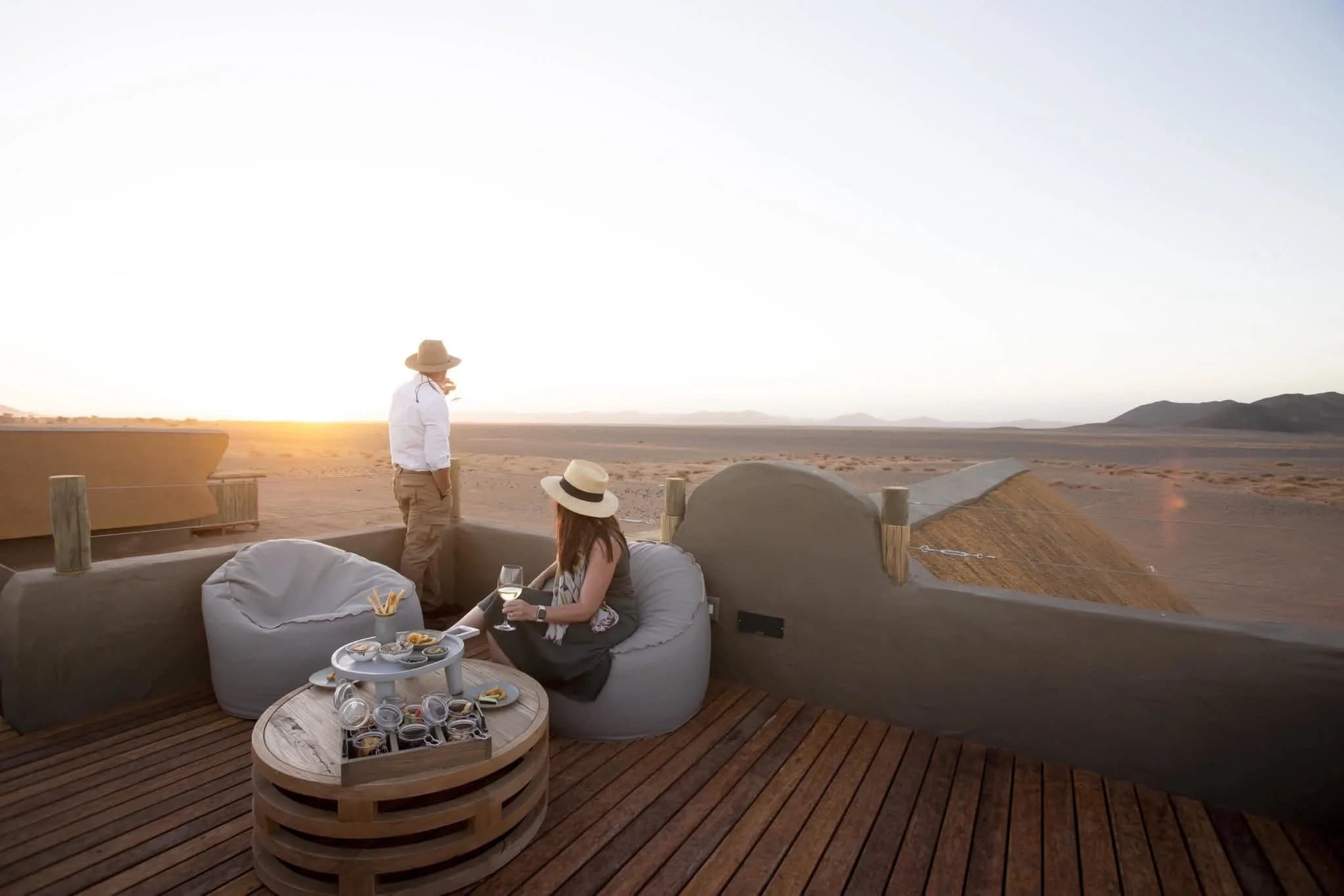 Luxury Namibian lodge sundowner deck overlooking the desert at sunset
